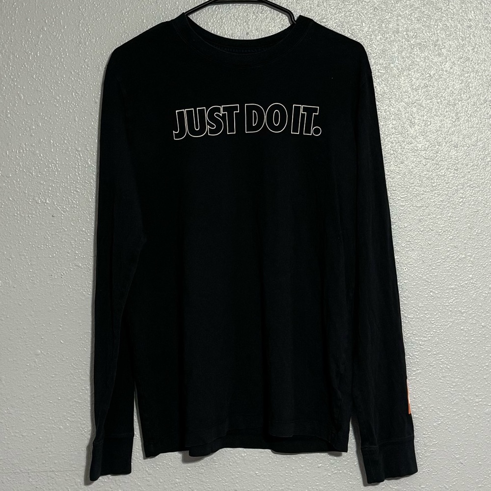 It’s a medium, black Nike long sleeve, it says just do it on the front.